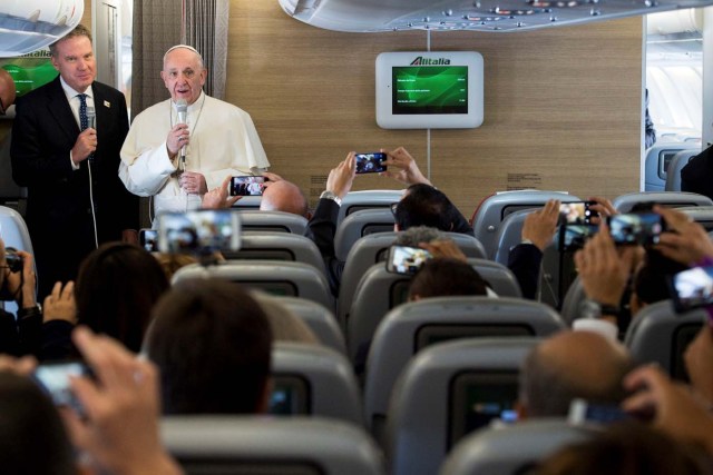 Pope Francis talks aboard a plane for his 5-days pastoral visit to Colombia at Fiumicino international airport in Rome, Italy, September 6, 2017. Osservatore Romano/Handout via REUTERS ATTENTION EDITORS - THIS IMAGE WAS PROVIDED BY A THIRD PARTY. NO RESALES. NO ARCHIVE.