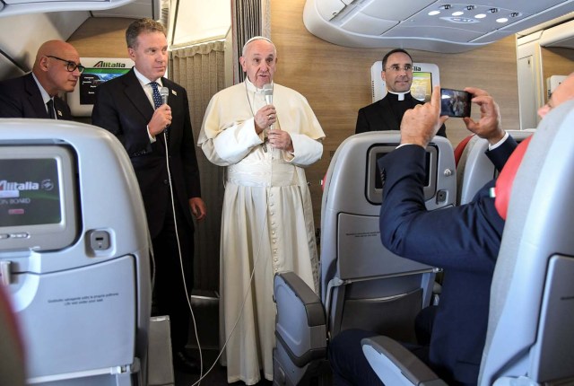 Pope Francis talks aboard a plane for his 5-days pastoral visit to Colombia at Fiumicino international airport in Rome, Italy, September 6, 2017. REUTERS/Alessandro Di Meo/Pool