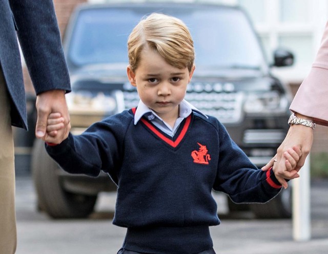 Prince George holds his father Britain's Prince William's hand as he arrives on his first day of school at Thomas's school in Battersea, London, September 7, 2017. REUTERS/Richard Pohle/Pool