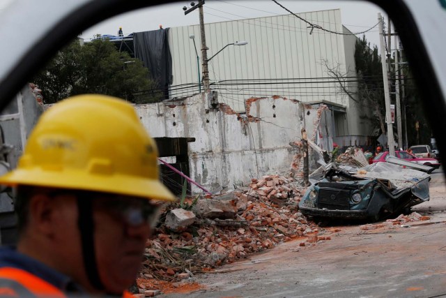 A damaged wall and a smashed vehicle are pictured after an earthquake in Mexico City, Mexico September 8, 2017. REUTERS/Carlos Jasso