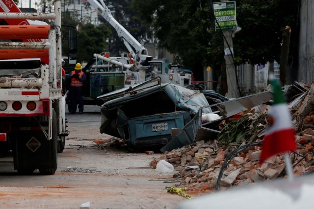 A damaged wall and a smashed vehicle are pictured after an earthquake in Mexico City, Mexico September 8, 2017. REUTERS/Carlos Jasso