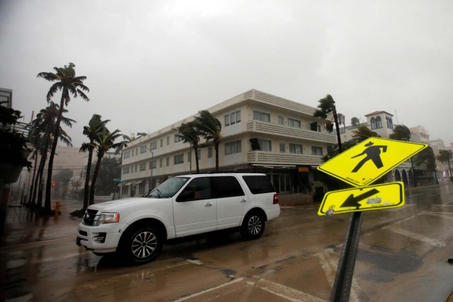 A vehicle drives along Ocean Drive in South Beach as Hurricane Irma arrives at south Florida, in Miami Beach, Florida, U.S., September 10, 2017. REUTERS/Carlos Barria