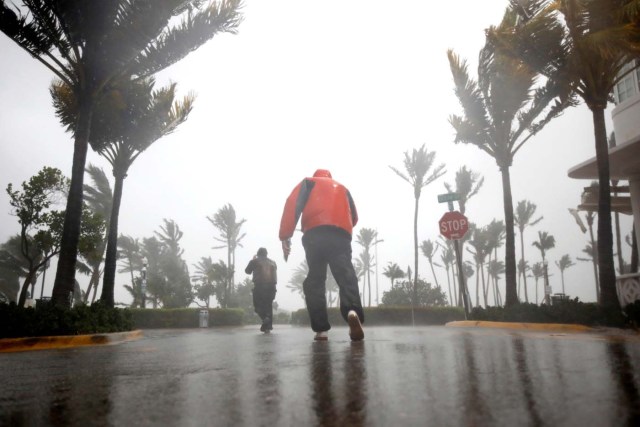 People walk along a street in South Beach as Hurricane Irma arrives at south Florida, in Miami Beach, Florida, U.S., September 10, 2017. REUTERS/Carlos Barria