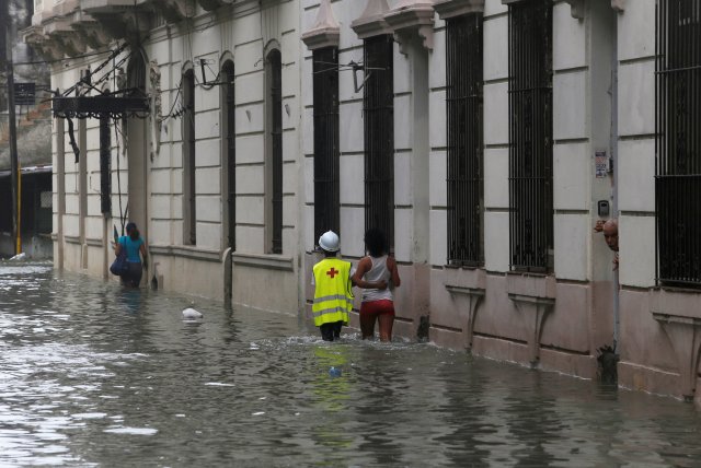 People wade through a flooded street after the passing of Hurricane Irma, in Havana, Cuba, September 10, 2017. REUTERS/Stringer NO SALES. NO ARCHIVES