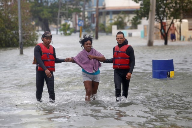 Rescue personnel help a woman after the passing of Hurricane Irma, in Havana, Cuba, September 10, 2017. REUTERS/Stringer NO SALES. NO ARCHIVES