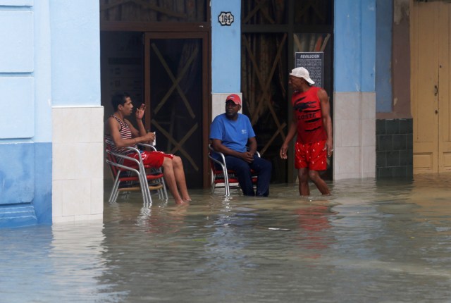 People sit in a flooded street, after the passing of Hurricane Irma, in Havana, Cuba, September 10, 2017. REUTERS/Stringer NO SALES. NO ARCHIVES