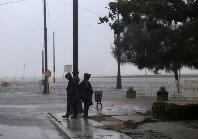 Police stand guard near the flooded seafront boulevard El Malecon, after the passing of Hurricane Irma, in Havana, Cuba, September 10, 2017. REUTERS/Stringer NO SALES. NO ARCHIVES