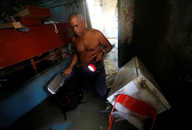 A man wades through the water in his flooded home after the passing of Hurricane Irma in Havana, Cuba, September 10, 2017. REUTERS/Stringer NO SALES. NO ARCHIVES