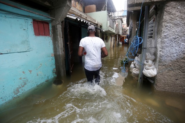 A man walks through the flooded passage of a block of flats, after the passing of Hurricane Irma, in Havana, Cuba September 10, 2017. REUTERS/Stringer NO SALES. NO ARCHIVES