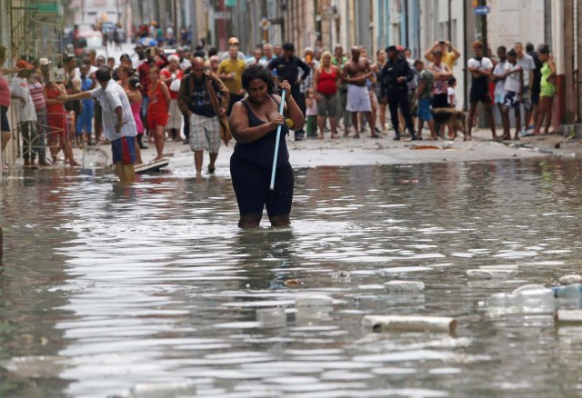 REFILE - QUALITY REPEAT A woman wades through the water after the passing of Hurricane Irma, in Havana, Cuba September 10, 2017. REUTERS/Stringer NO SALES. NO ARCHIVES