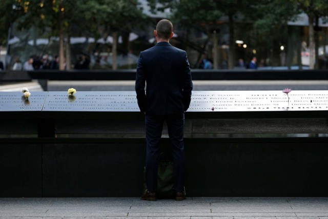 A man pauses at the edge of the South reflecting pool at the National September 11 Memorial and Museum during ceremonies marking the 16th anniversary of the September 11, 2001 attacks in New York, U.S, September 11, 2017. REUTERS/Brendan McDermid
