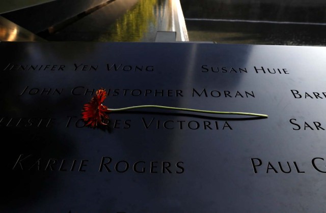 A flower rests over names at the edge of the South reflecting pool at the National September 11 Memorial and Museum during ceremonies marking the 16th anniversary of the September 11, 2001 attacks in New York, U.S. September 11, 2017. REUTERS/Brendan McDermid