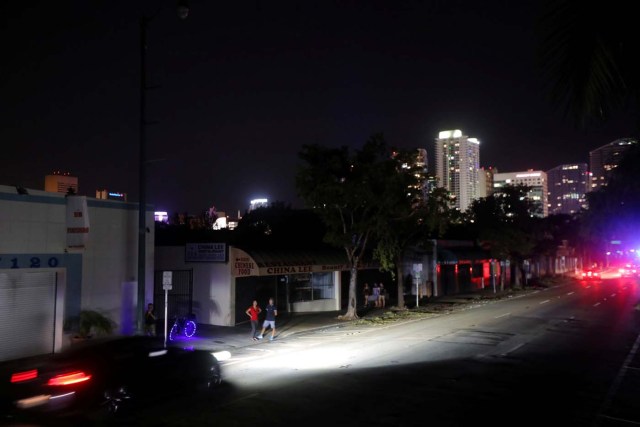 Local residents stand in the darkness as many areas of Miami still without electricity after Hurricane Irma strikes Florida, in Little Havana, Miami, Florida, September 11, 2017. REUTERS/Carlos Barria