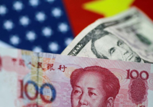 FILE PHOTO: U.S. Dollar and China Yuan notes are seen in this picture illustration June 2, 2017. REUTERS/Thomas White/Illustration/File Photo