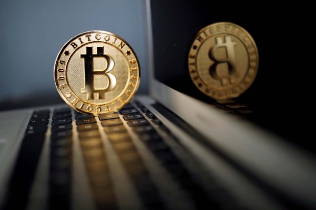 FILE PHOTO: A Bitcoin (virtual currency) coin is seen in an illustration picture taken at La Maison du Bitcoin in Paris, France, June 23, 2017. REUTERS/Benoit Tessier/Illustration/File Photo