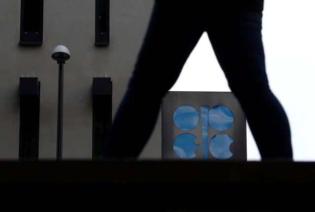 A person passes the logo of the Organization of the Petroleum Exporting Countries (OPEC) in front of its headquarters in Vienna, Austria September 21, 2017.   REUTERS/Leonhard Foeger