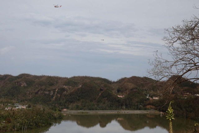 U.S. Coast Guard helicopters fly over the dam at the Guajataca lake after the area was hit by Hurricane Maria in Guajataca, Puerto Rico September 23, 2017. REUTERS/Carlos Garcia Rawlins