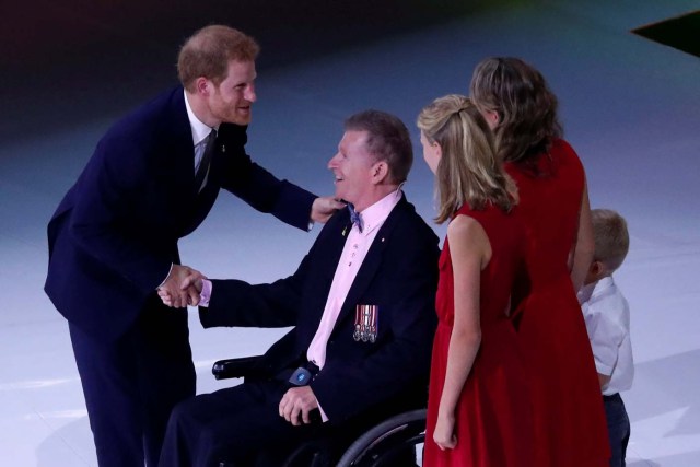 Britain's Prince Harry joins Captain Trevor Greene, a Canadian Forces former officer who suffered a wartime head injury in Afghanistan, and his family onstage during the opening ceremony of the Invictus Games in Toronto, Canada September 23, 2017. REUTERS/Jonathan Ernst