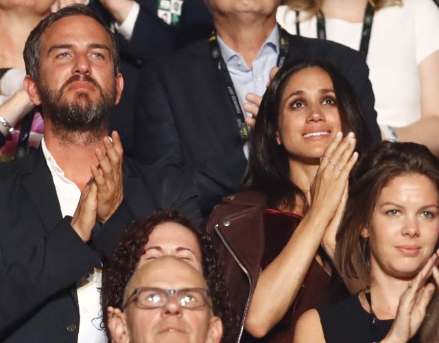 Meghan Markle (center, R, wearing dark red), girlfriend of Britain's Prince Harry, applauds as Prince Harry (not shown) addresses the opening ceremony for the Invictus Games in Toronto, Canada, September 23, 2017. REUTERS/Mark Blinch