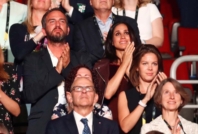 Meghan Markle (center, R, wearing maroon), girlfriend of Britain's Prince Harry, reacts as Prince Harry (not shown) addresses the opening ceremony for the Invictus Games in Toronto, Ontario, Canada September 23, 2017.    . REUTERS/Mark Blinch