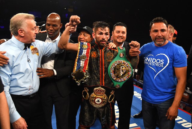 Sep 23, 2017; Los Angeles, CA, USA; Referee Jack Ries raises the arm of Jorge Linares as he stands next to Oscar De La Hoya after winning his WBA, WBC Diamond and Ring Lightweight Title fight against Luke Campbell (not pictured) at The Forum.  Linares won by decision. Mandatory Credit: Jayne Kamin-Oncea-USA TODAY Sports