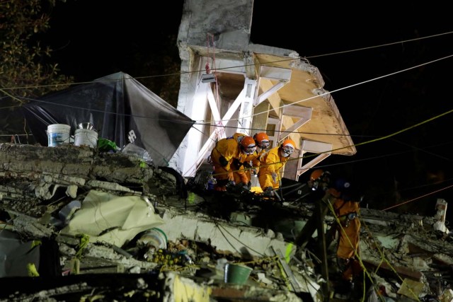 Members of a Japanese rescue team work in the rubble of a collapsed multi family residential, after an earthquake, in Mexico City, Mexico September 24, 2017. REUTERS/Jose Luis Gonzalez