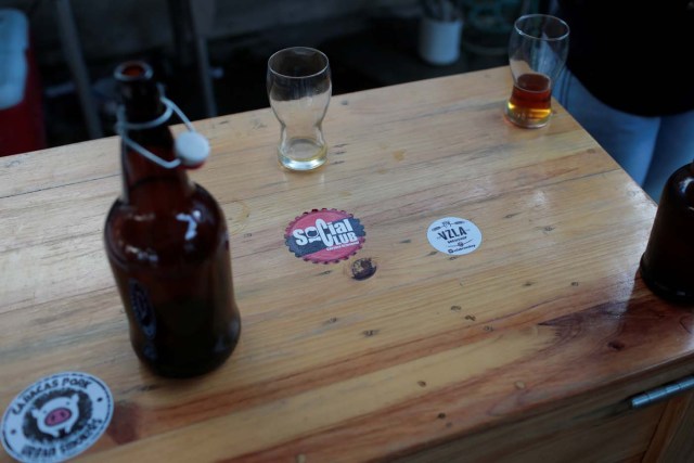 A sticker with the logo of Social Club brewery is seen on a table in a beer garden at the garage of the brewery in Caracas, Venezuela, September 15, 2017. Picture taken September 15, 2017. REUTERS/Marco Bello