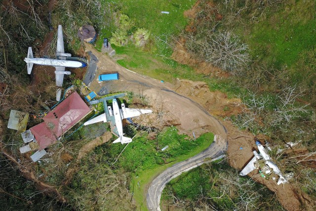 An airplane themed restaurant is seen damaged by mudslides and winds in Barranquitas, southwest of San Juan, Puerto Rico, on September 24, 2017 following the passage of Hurricane Maria. Authorities in Puerto Rico rushed on September 23, 2017 to evacuate people living downriver from a dam said to be in danger of collapsing because of flooding from Hurricane Maria. / AFP PHOTO / Ricardo ARDUENGO