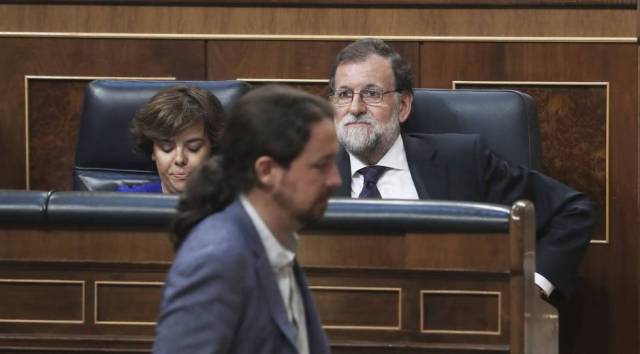 Pablo Iglesias, ante Mariano Rajoy y Soraya Sáenz de Santamaría. / ULY MARTÍN