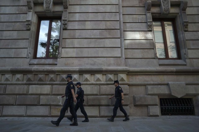Police officers patrol outside the High Court of Catalonia in Barcelona on October 10, 2017. Spain's worst political crisis in a generation will come to a head as Catalonia's leader could declare independence from Madrid in a move likely to send shockwaves through Europe. / AFP PHOTO / JORGE GUERRERO