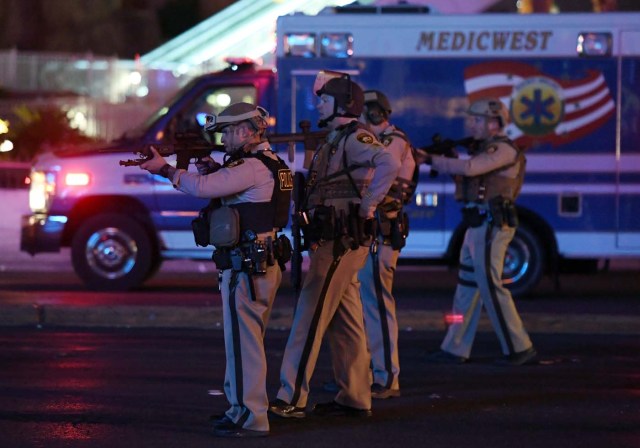 LAS VEGAS, NV - OCTOBER 02: Police officers point their weapons at a car driving down closed Tropicana Ave. near Las Vegas Boulevard after a reported mass shooting at a country music festival nearby on October 2, 2017 in Las Vegas, Nevada. A gunman has opened fire on a music festival in Las Vegas, leaving at least 2 people dead. Police have confirmed that one suspect has been shot. The investigation is ongoing. Ethan Miller/Getty Images/AFP