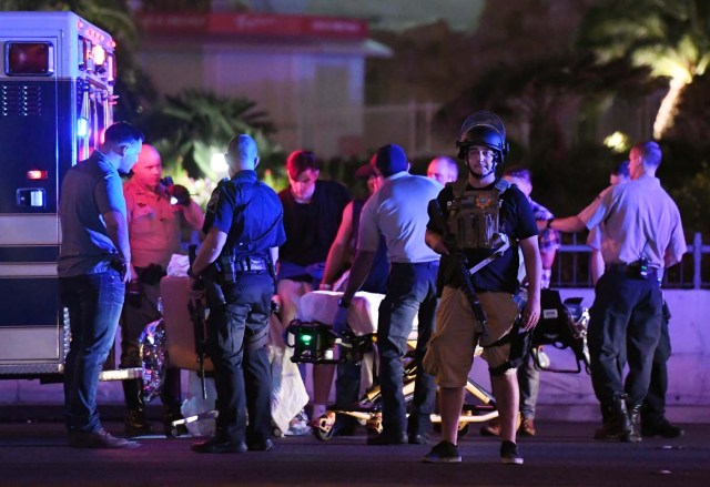 LAS VEGAS, NV - OCTOBER 02: Police officers stand by as medical personnel tend to a person on Tropicana Ave. near Las Vegas Boulevard after a mass shooting at a country music festival nearby on October 2, 2017 in Las Vegas, Nevada .A gunman has opened fire on a music festival in Las Vegas, leaving over 20 people dead. Police have confirmed that one suspect has been shot. The investigation is ongoing. Ethan Miller/Getty Images/AFP