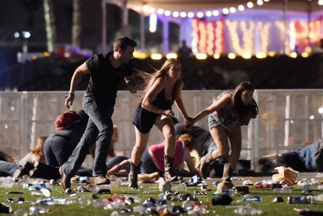LAS VEGAS, NV - OCTOBER 01: People run from the Route 91 Harvest country music festival after apparent gun fire was hear on October 1, 2017 in Las Vegas, Nevada. A gunman has opened fire on a music festival in Las Vegas, leaving at least 20 people dead and more than 100 injured. Police have confirmed that one suspect has been shot. The investigation is ongoing. David Becker/Getty Images/AFP