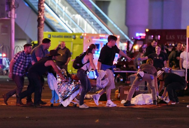LAS VEGAS, NV - OCTOBER 02: An injured person is tended to in the intersection of Tropicana Ave. and Las Vegas Boulevard after a mass shooting at a country music festival nearby on October 2, 2017 in Las Vegas, Nevada. A gunman has opened fire on a music festival in Las Vegas, killing over 20 people. Police have confirmed that one suspect has been shot dead. The investigation is ongoing. Ethan Miller/Getty Images/AFP