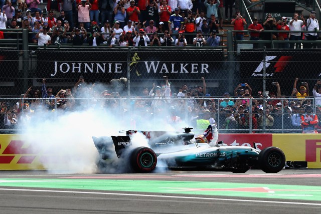 MEXICO CITY, MEXICO - OCTOBER 29: Lewis Hamilton of Great Britain and Mercedes GP celebrates with donuts on track after winning his fourth F1 World Drivers Championship during the Formula One Grand Prix of Mexico at Autodromo Hermanos Rodriguez on October 29, 2017 in Mexico City, Mexico. Mark Thompson/Getty Images/AFP
