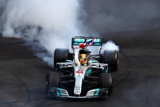 MEXICO CITY, MEXICO - OCTOBER 29: Lewis Hamilton of Great Britain and Mercedes GP celebrates with donuts on track after winning his fourth F1 World Drivers Championship during the Formula One Grand Prix of Mexico at Autodromo Hermanos Rodriguez on October 29, 2017 in Mexico City, Mexico. Clive Rose/Getty Images/AFP