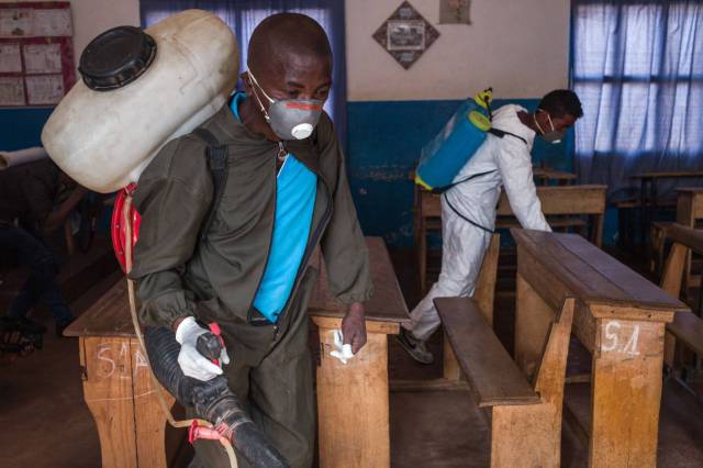 Trabajadores del Ministerio de Salud usan pesticida en una escuela de Andraisoro, Madagascar, para combatir la peste. RIJASOLO AFP 