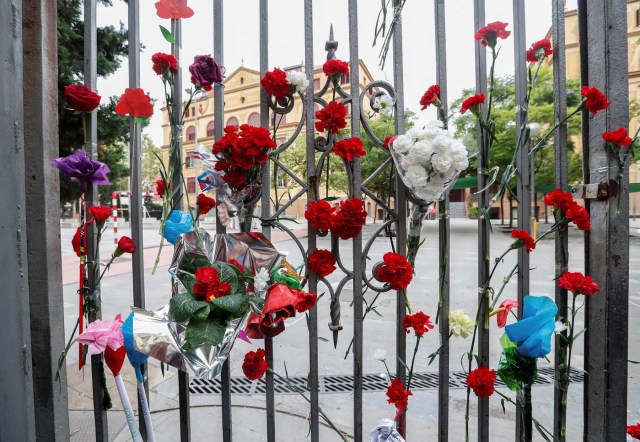 Flowers are placed on the gate of the Ramon Llull high school where Spanish police clashed with voters during the banned referendum in Barcelona, Spain October 3, 2017. REUTERS/Yves Herman