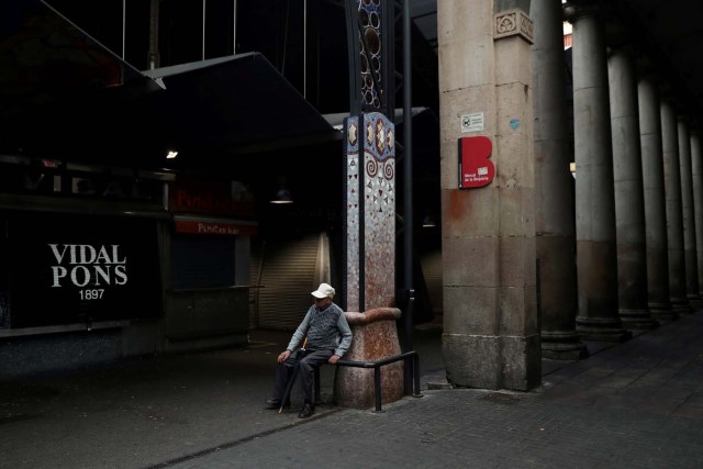 An old man sits outside an almost closed La Boqueria market during a partial regional strike called by pro-independence parties and unions in Barcelona, Spain, October 3, 2017. REUTERS/Susana Vera TPX IMAGES OF THE DAY