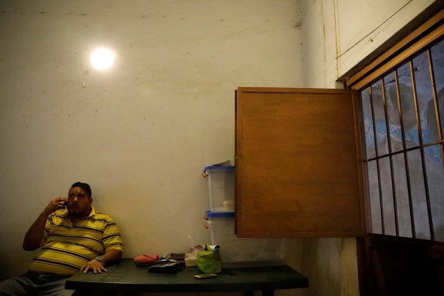Medical equipment repairman Leandro Colmenares speaks by phone at his house in Caracas, Venezuela October 3, 2017. Picture taken October 3, 2017. REUTERS/Carlos Garcia Rawlins