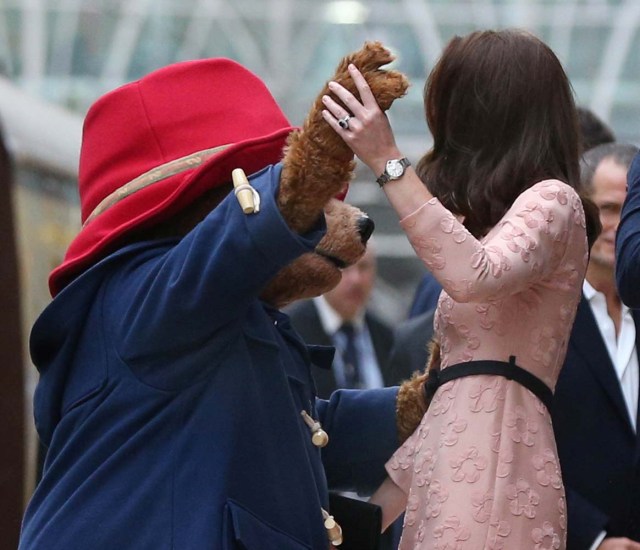Britain's Catherine the Duchess of Cambridge dances with a costumed figure of Paddington bear on platform 1 at Paddington Station, as they attend the Charities Forum in London, October 16, 2017. REUTERS/Jonathan Brady/Pool