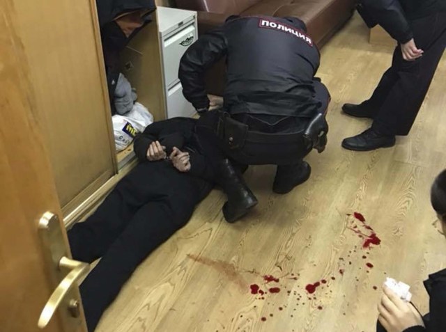 Policemen detain an intruder, who attacked Tatyana Felgengauer, anchor of Russian radio station Ekho Moskvy, in Moscow, Russia October 23, 2017. REUTERS/Vitaly Ruvinskiy FOR EDITORIAL USE ONLY. NO RESALES. NO ARCHIVES.