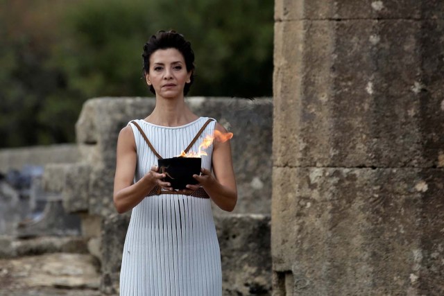 Olympics - Lighting Ceremony of the Olympic Flame Pyeongchang 2018 - Ancient Olympia, Olympia, Greece - October 24, 2017 Greek actress Katerina Lehou, playing the role of High Priestess and actresses carries the Olympic Flame during the Olympic flame lighting ceremony for the Pyeongchang 2018 Winter Olympics REUTERS/Alkis Konstantinidis