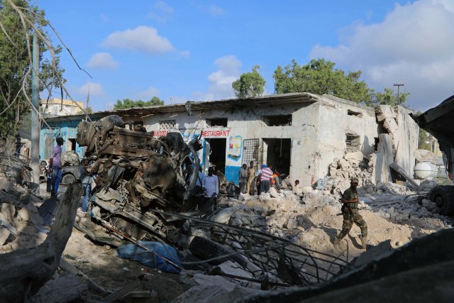 Somali security assess the scene of a suicide car bomb explosion, at the gate of Naso Hablod Two Hotel in Hamarweyne district of Mogadishu, Somalia October 29, 2017. REUTERS/Feisal Omar