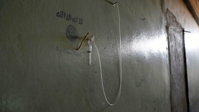 Un catéter y una manguera de suero para infusiones intravenosas cuelgan en la pared de un precario e improvisado hospital de los yihadistas, hallado debajo del estadio en Raqa. 18 de octubre de 2017.