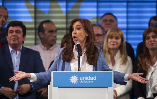 Argentina's former President and Buenos Aires senatorial candidate for the Unidad Ciudadana Party, Cristina Fernandez de Kirchner (C) delivers a speech at Arsenal Club stadium in Sarandi, near Buenos Aires on October 22, 2017. Ex-president Cristina Kirchner won a Senate seat in Argentina's mid-term elections Sunday, capping a return to the political fray and guaranteeing her immunity from a slew of corruption charges. / AFP PHOTO / ALEJANDRO PAGNI
