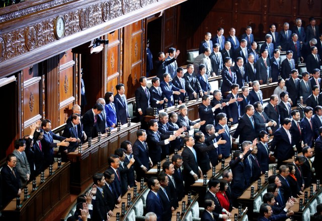 Lawmakers raise their hands and shouts "banzai" (cheers) after the dissolution of lower house was announced at the Parliament in Tokyo, Japan September 28, 2017.  REUTERS/Toru Hanai