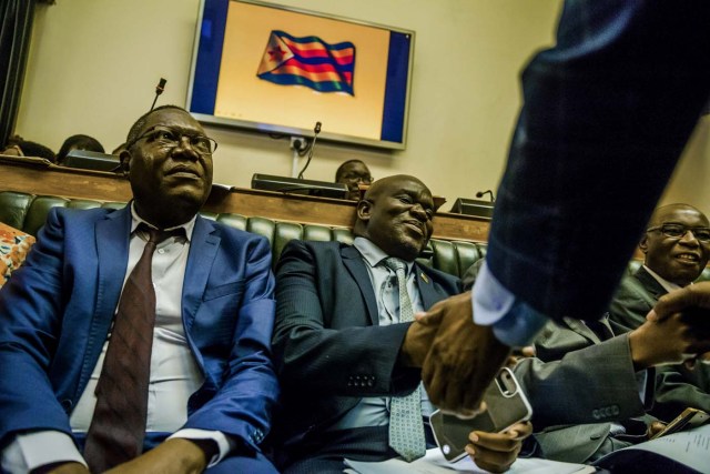 Zimbabwean Members of Parliament sit in the house of assembly during a parliamentary session where a motion is moved to impeach President Robert Mugabe November 21, 2017 at the Zimbabwean Parliament in Harare, Zimbabwe. Zimbabwe's parliament prepared to start impeachment proceedings against President Robert Mugabe Tuesday, as ousted vice president Emmerson Mnangagwa, who could be the country's next leader, told him to step down. Further street protests have been called in Harare, raising fears that the political turmoil could spill into violence. / AFP PHOTO / Jekesai NJIKIZANA