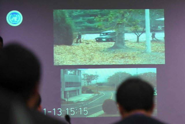 A surveillance TV footage containing the moment of defection of a North Korean Soldier, is seen during a press briefing by the United Nations Command at the Defence Ministry in Seoul on November 22, 2017. A North Korean soldier crossed the border into the South in breach of a 1953 armistice agreement as he pursued a defector who was shot last week, the US-led United Nations Command (UNC) said on November 22. / AFP PHOTO / JUNG Yeon-Je