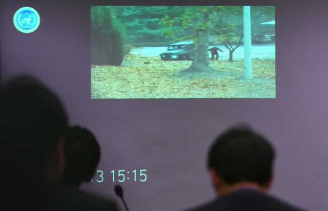 A surveillance TV footage containing the moment of defection of a North Korean Soldier, is seen during a press briefing by the United Nations Command at the Defence Ministry in Seoul on November 22, 2017. A North Korean soldier crossed the border into the South in breach of a 1953 armistice agreement as he pursued a defector who was shot last week, the US-led United Nations Command (UNC) said on November 22. / AFP PHOTO / JUNG Yeon-Je